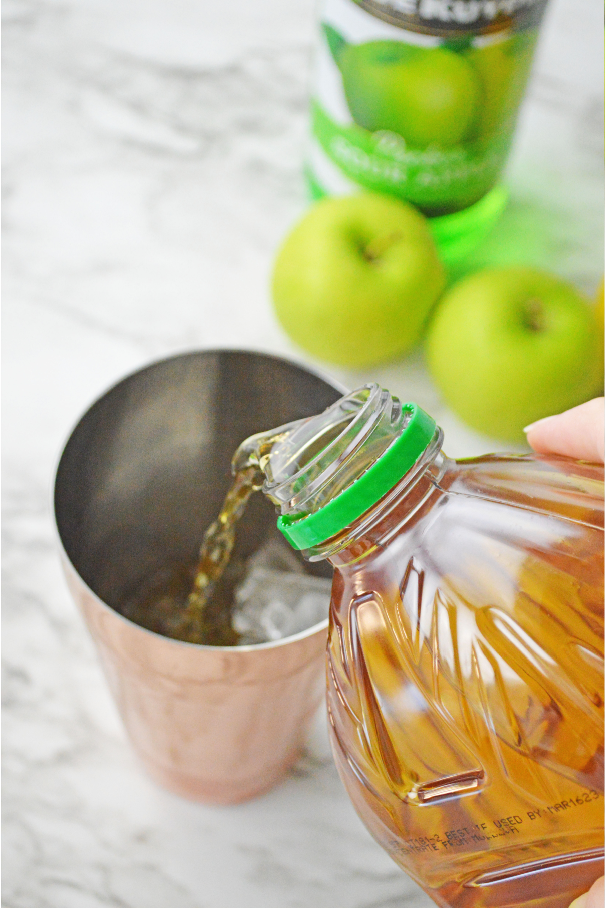 Pouring apple juice into shaker