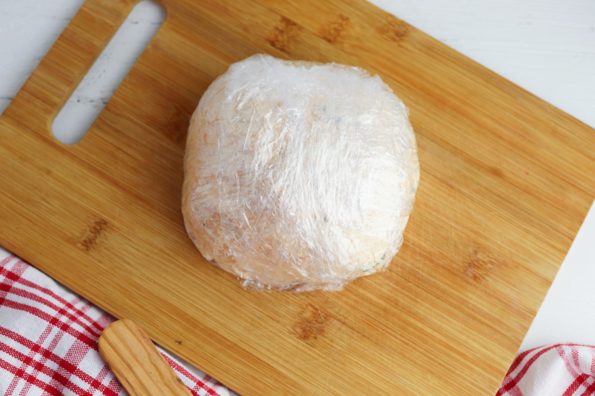 Cheese ball wrapped in plastic wrap