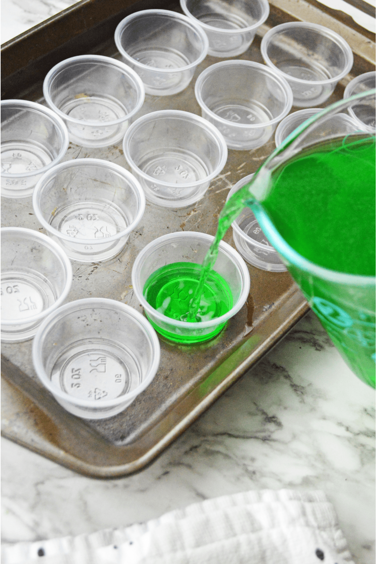Pouring lime jello into jello cups
