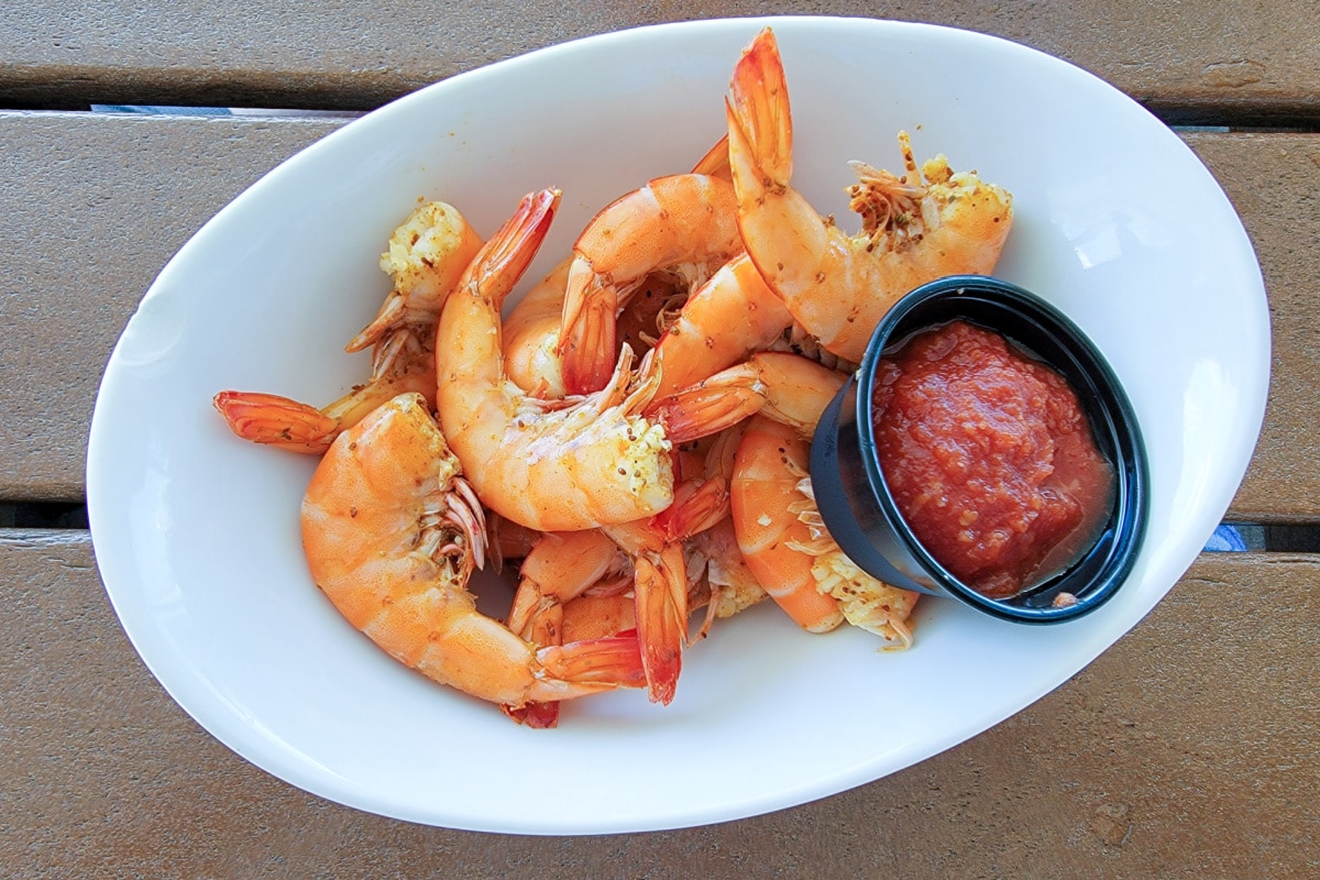 Bowl of peel and eat shrimp with cocktail sauce