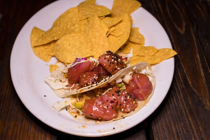 Tuna tacos with chips on white plate