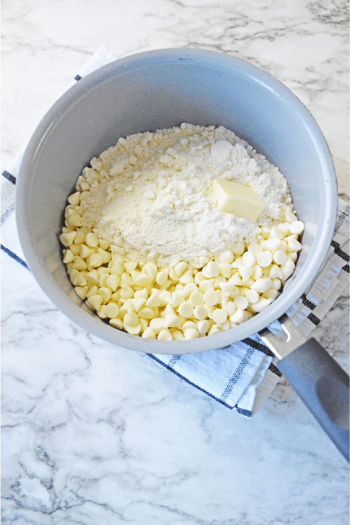 Cookie mix in saucepan with butter and white chocolate