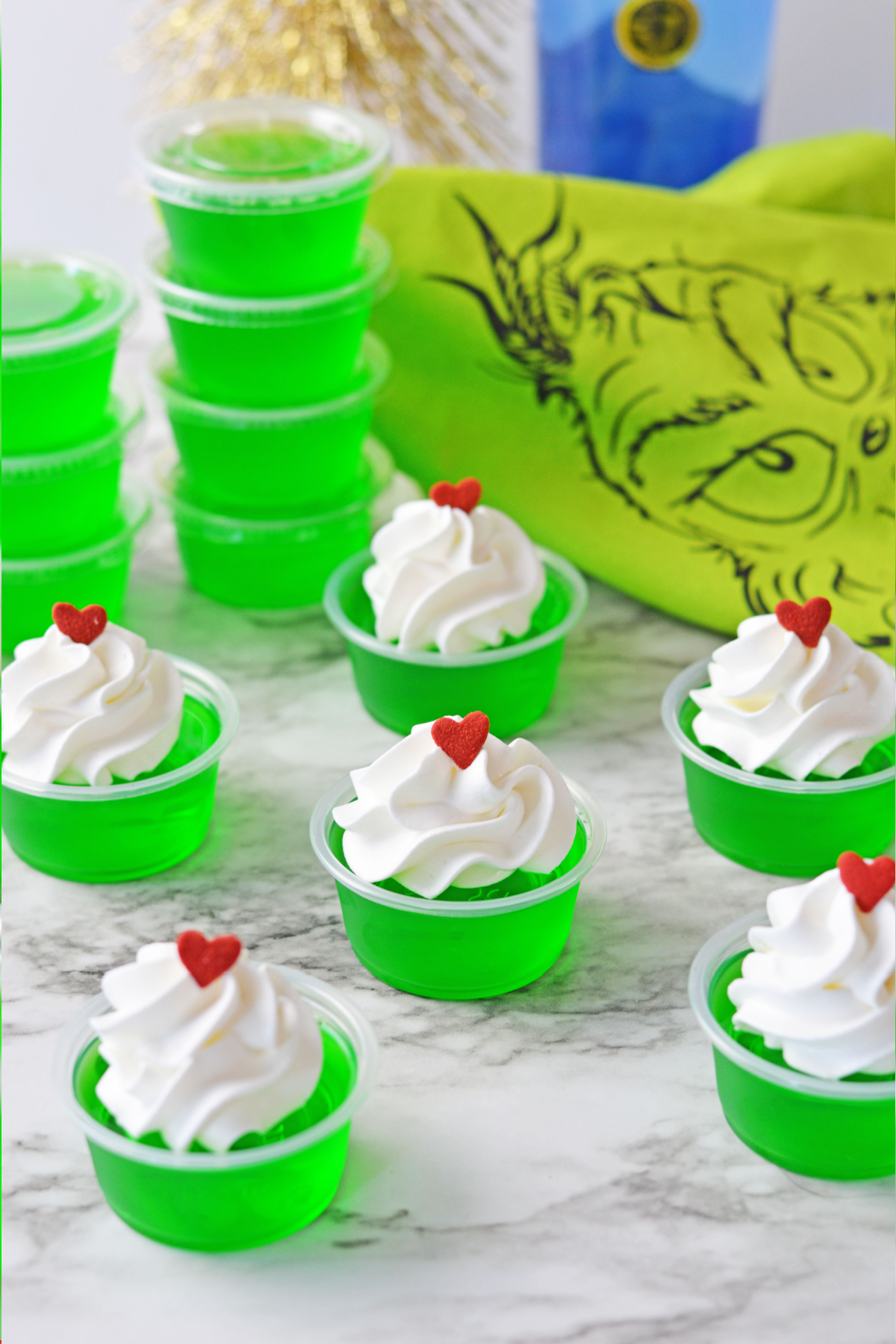 Grinch jello shots with extra shots stacked in background