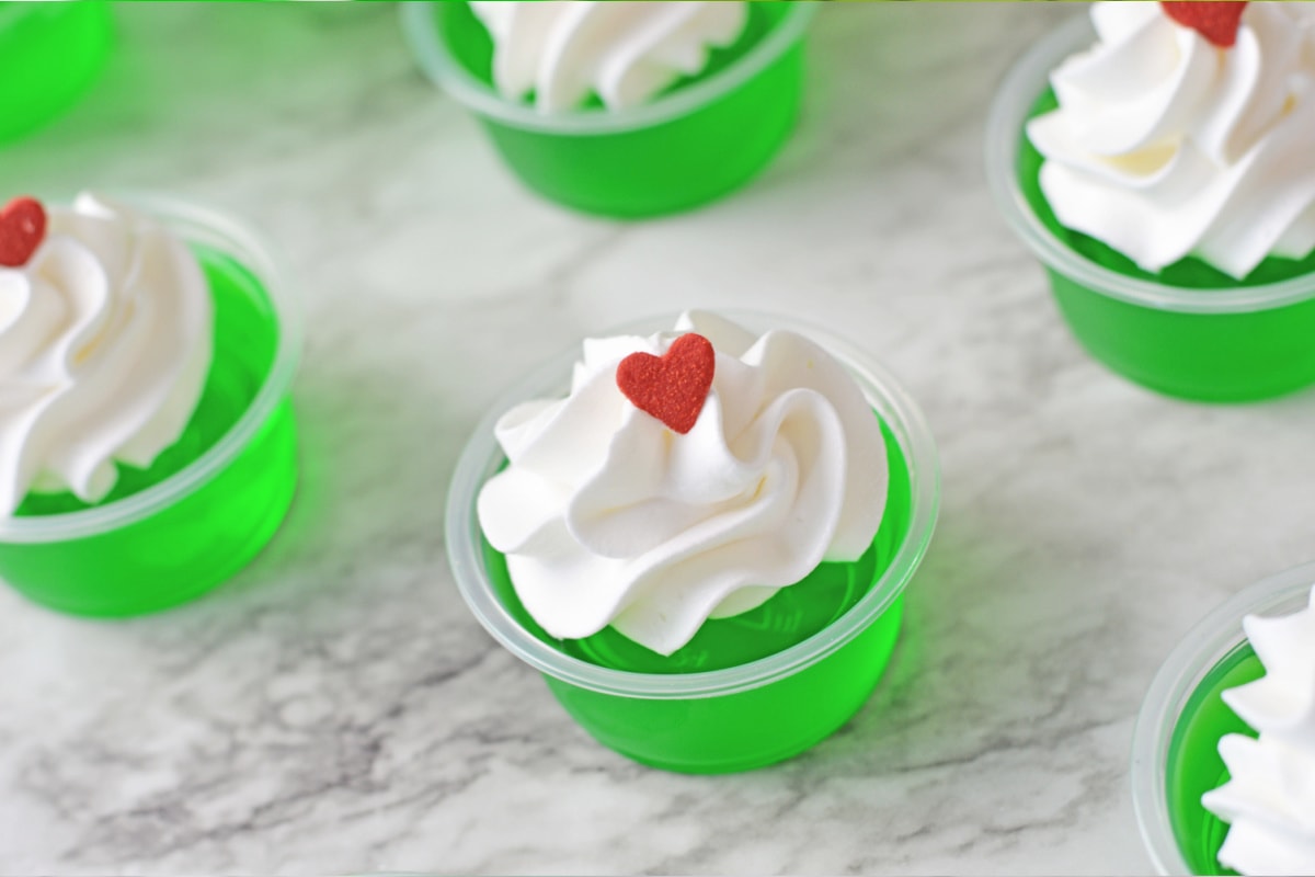 Grinch jello shots topped with a heart
