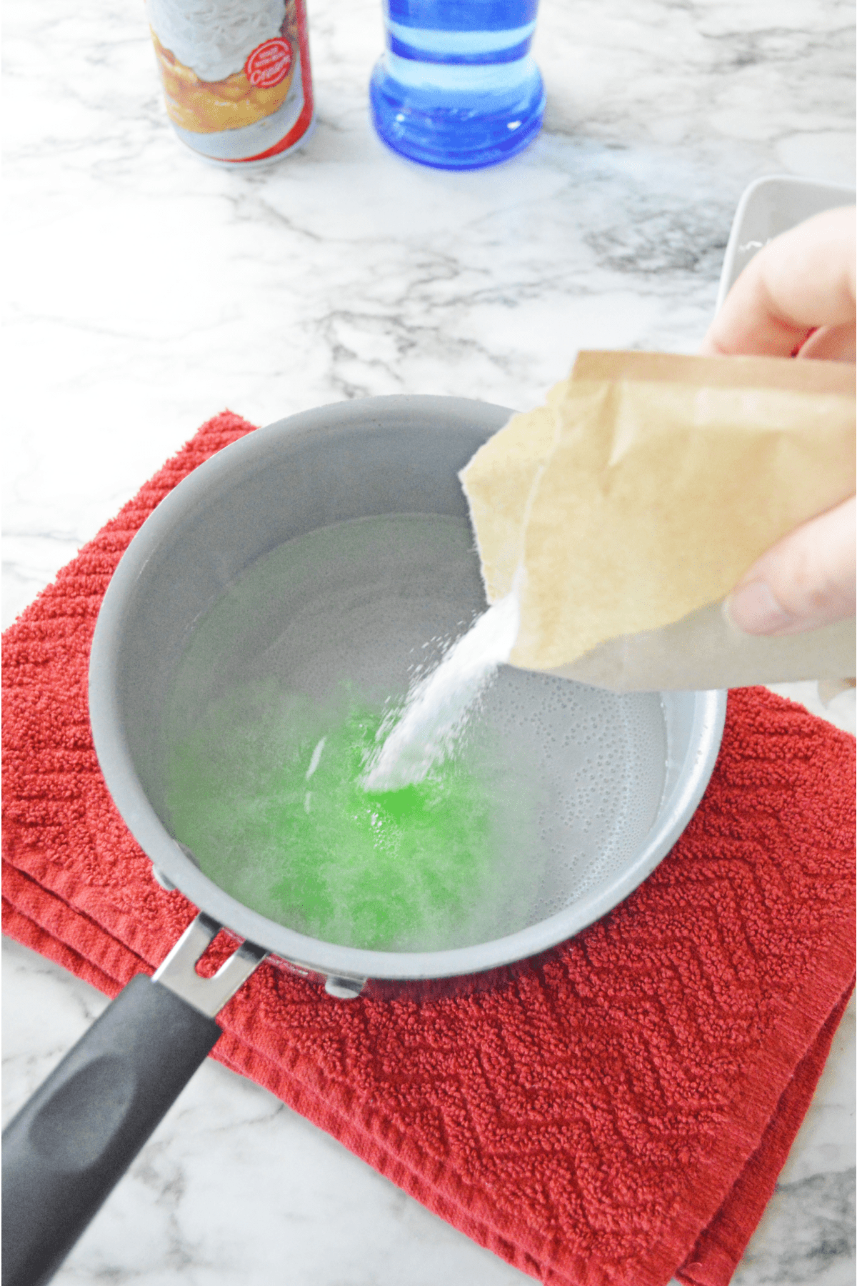 Pouring Jello powder into hot water