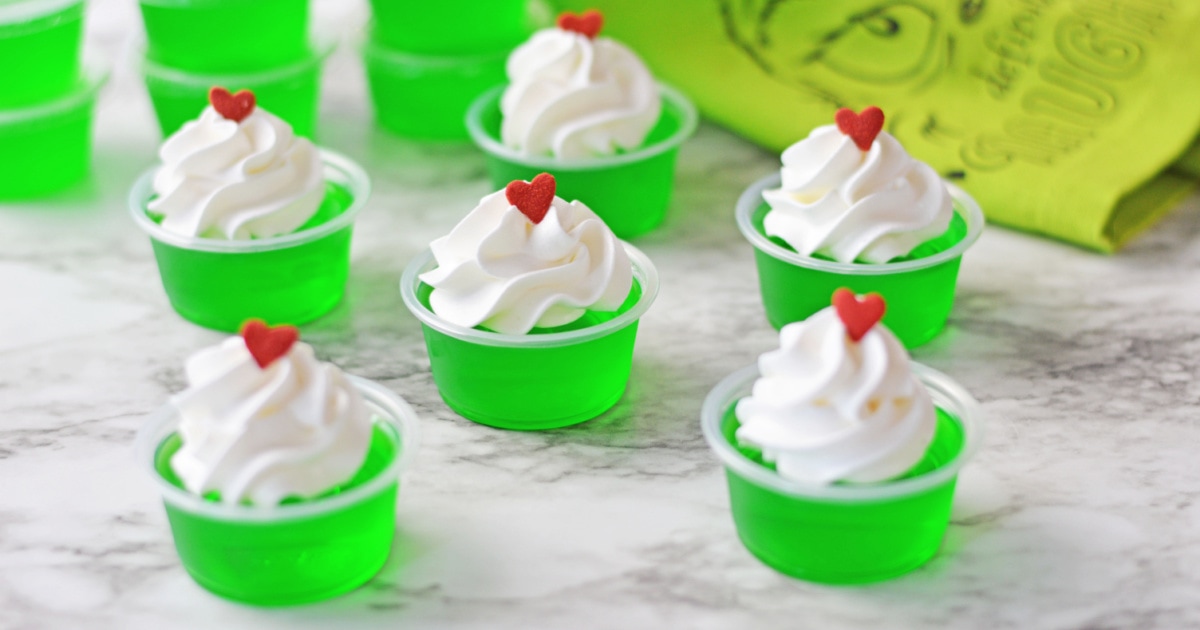 Grinch Jello shots with whipped cream and a red heart