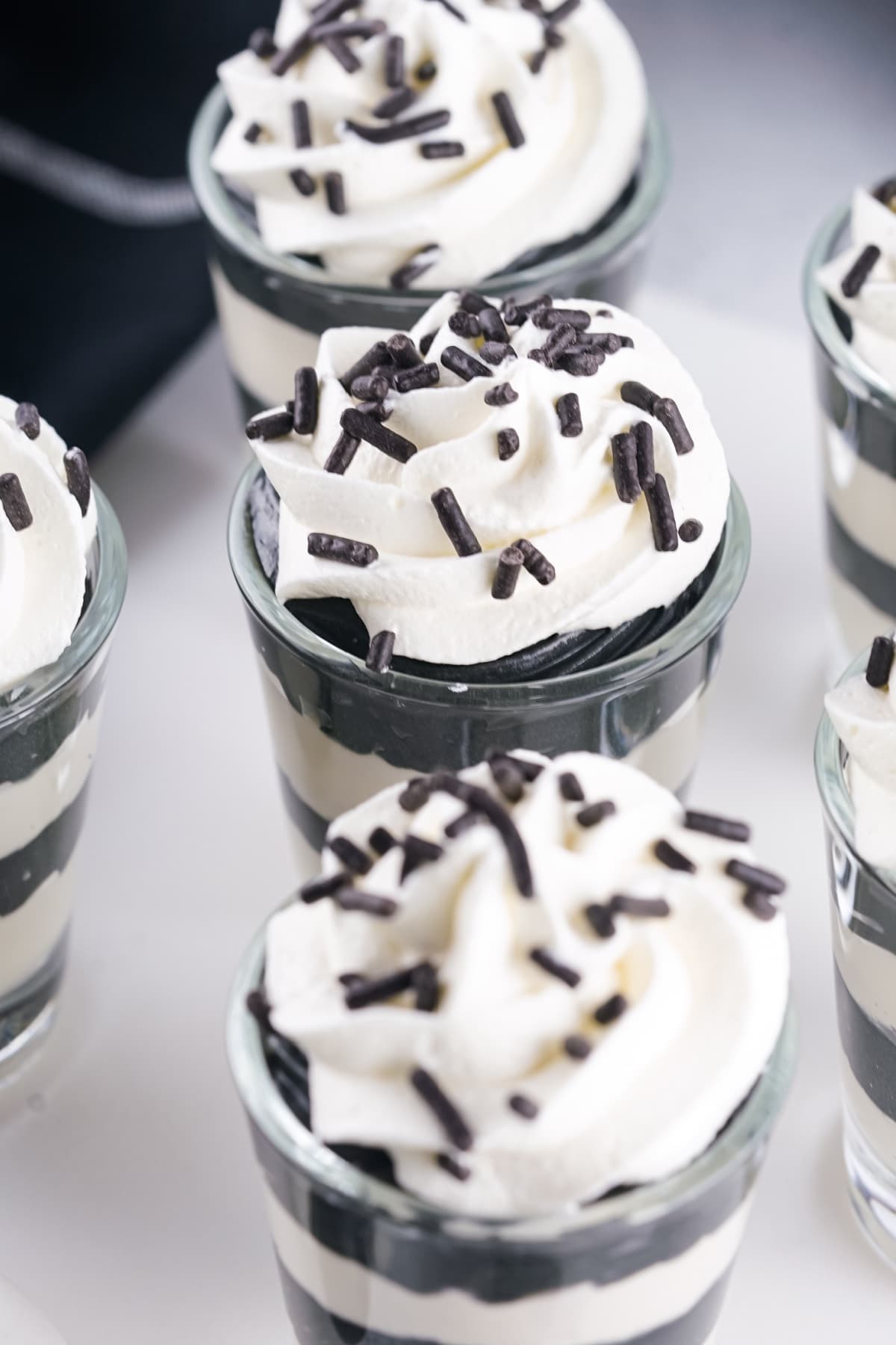 Halloween pudding shots with whipped cream and sprinkles