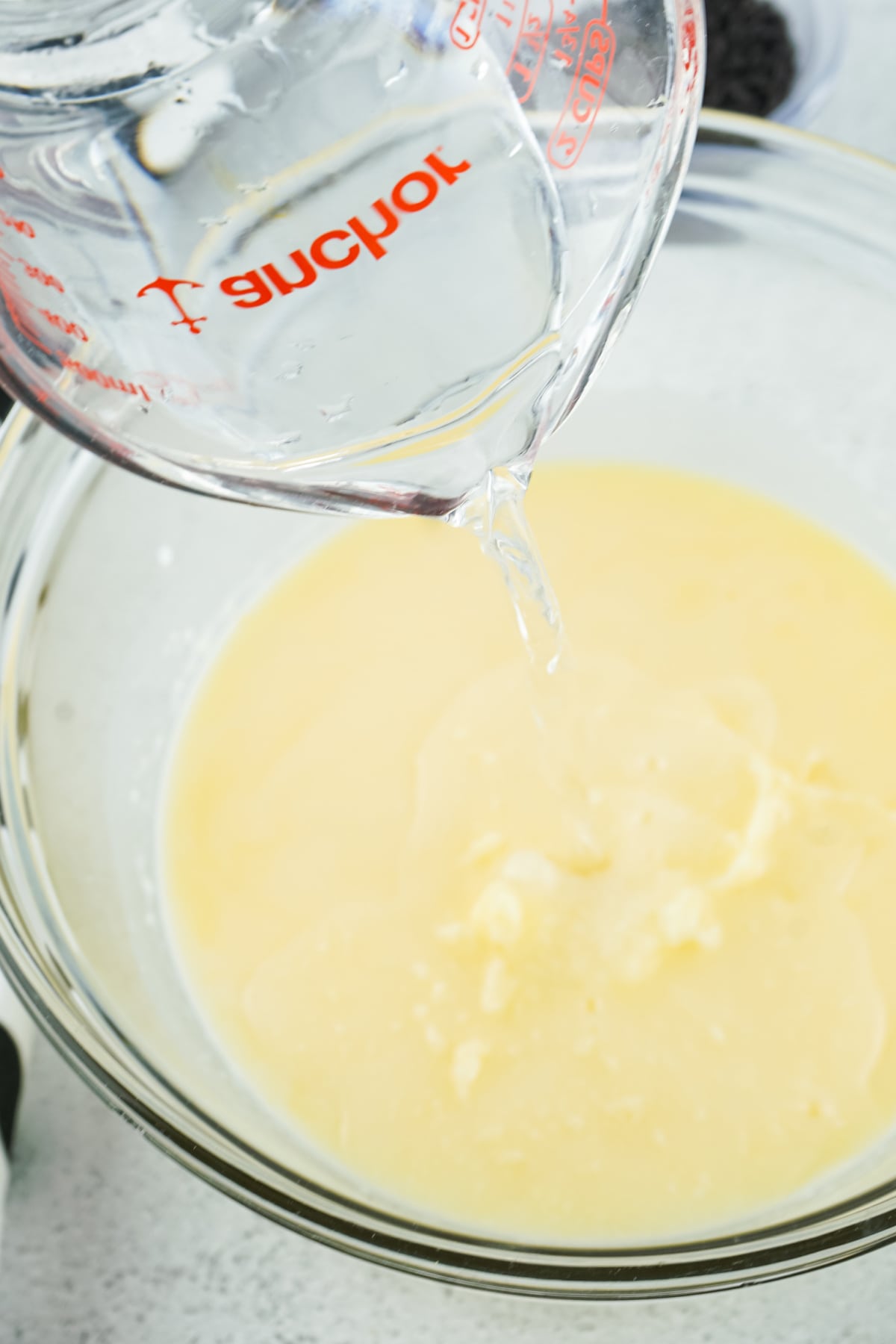 Vodka being mixed with pudding