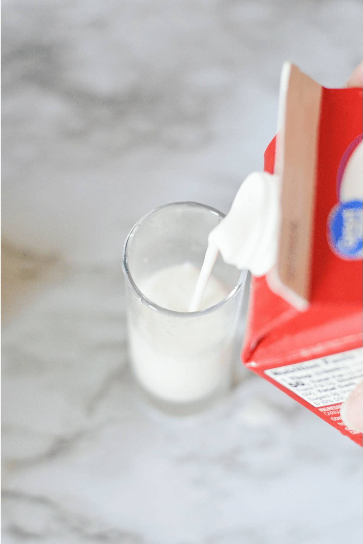Pouring heavy whipping cream into shot glass