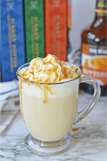Hot boozy butterbeer in clear glass mug