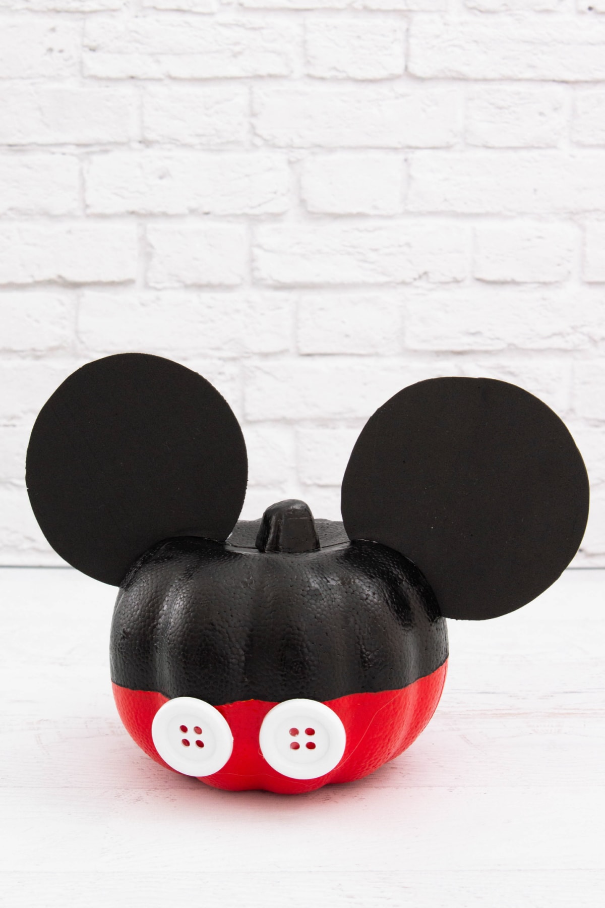 Mickey Mouse Painted Pumpkin with brick background