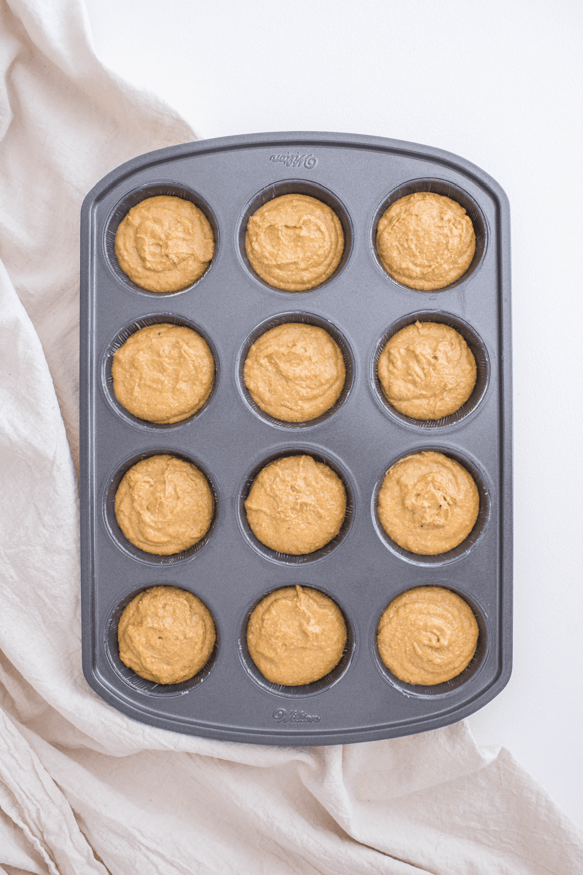 Pumpkin oatmeal muffin batter in muffin pan
