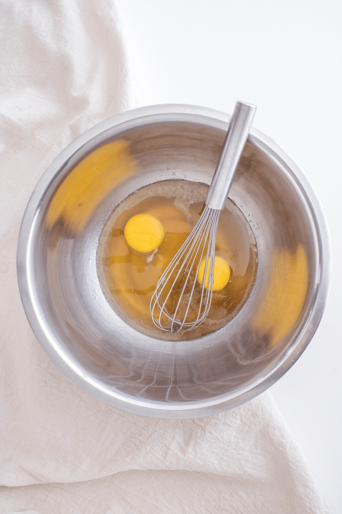 Eggs in bowl with syrup and oil