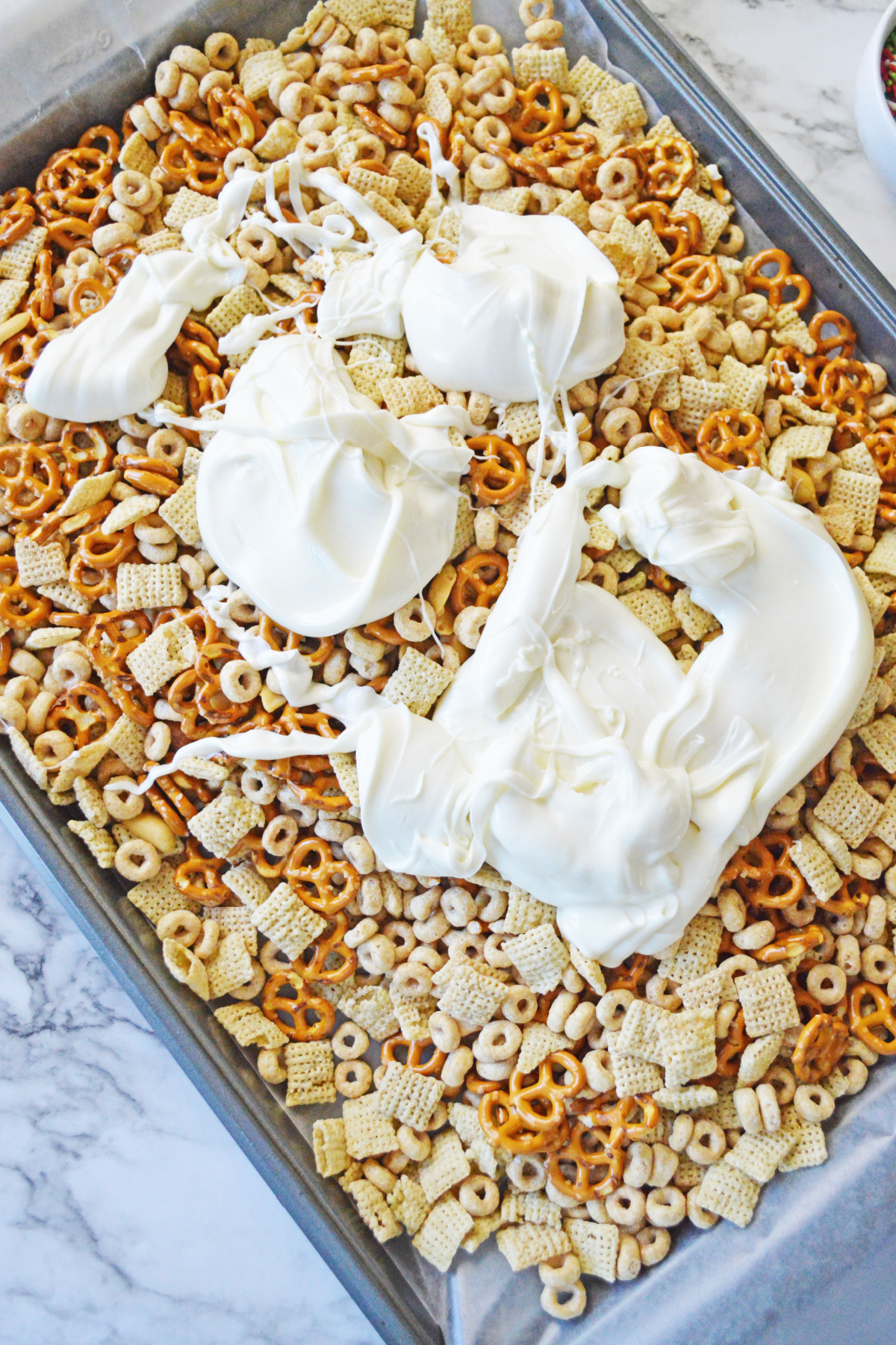 White chocolate poured over Chex mix