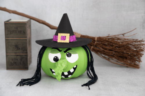 Witch pumpkin with spellbook and broom