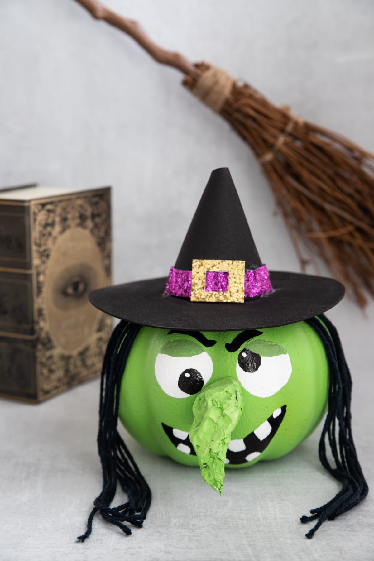Witch pumpkin with book and broom