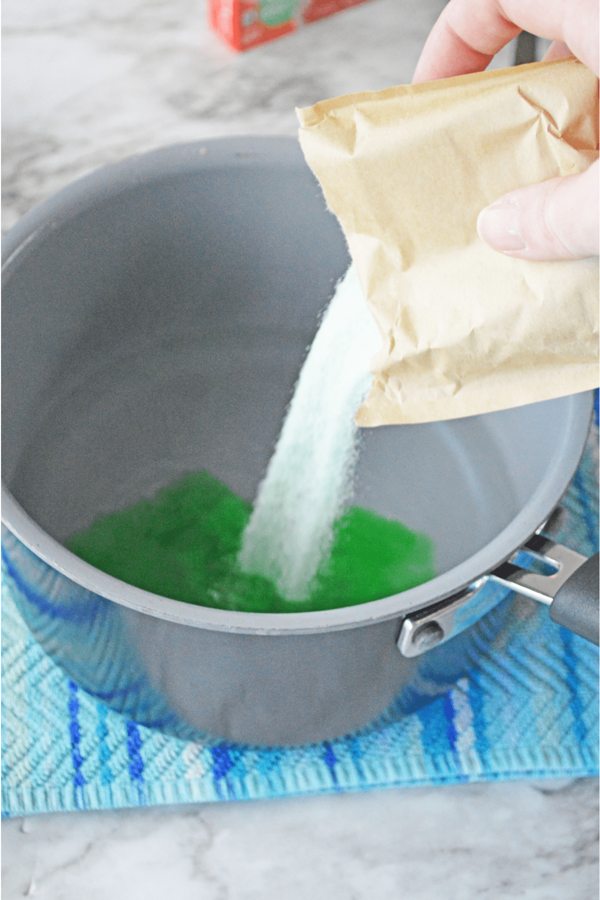 Pouring jello mix into saucepan