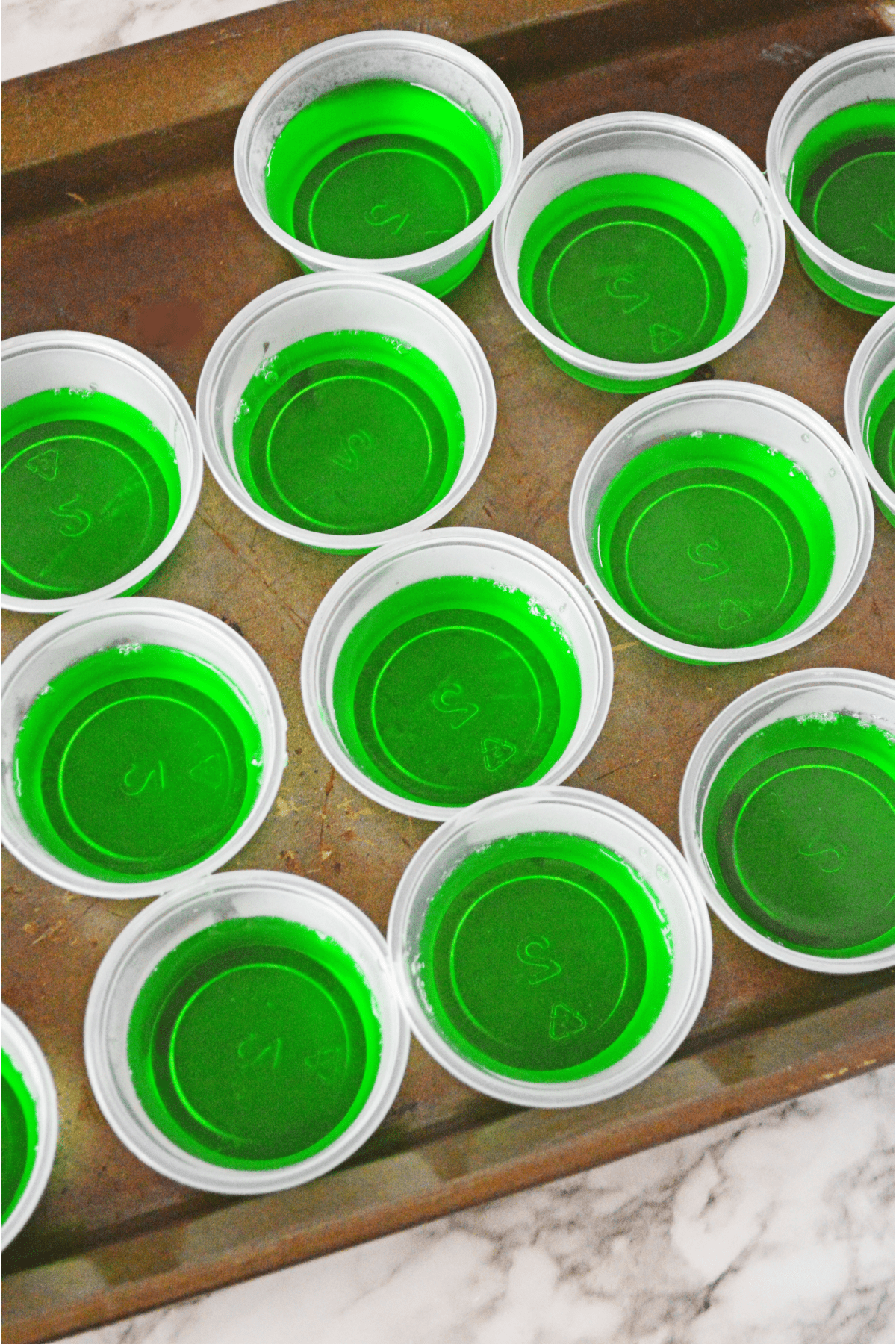 Green jello in plastic shot cups