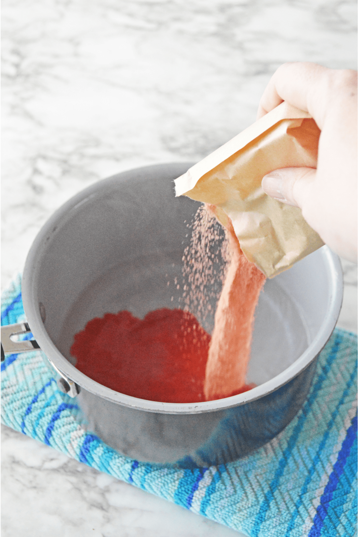 Red jello mix poured into saucepan