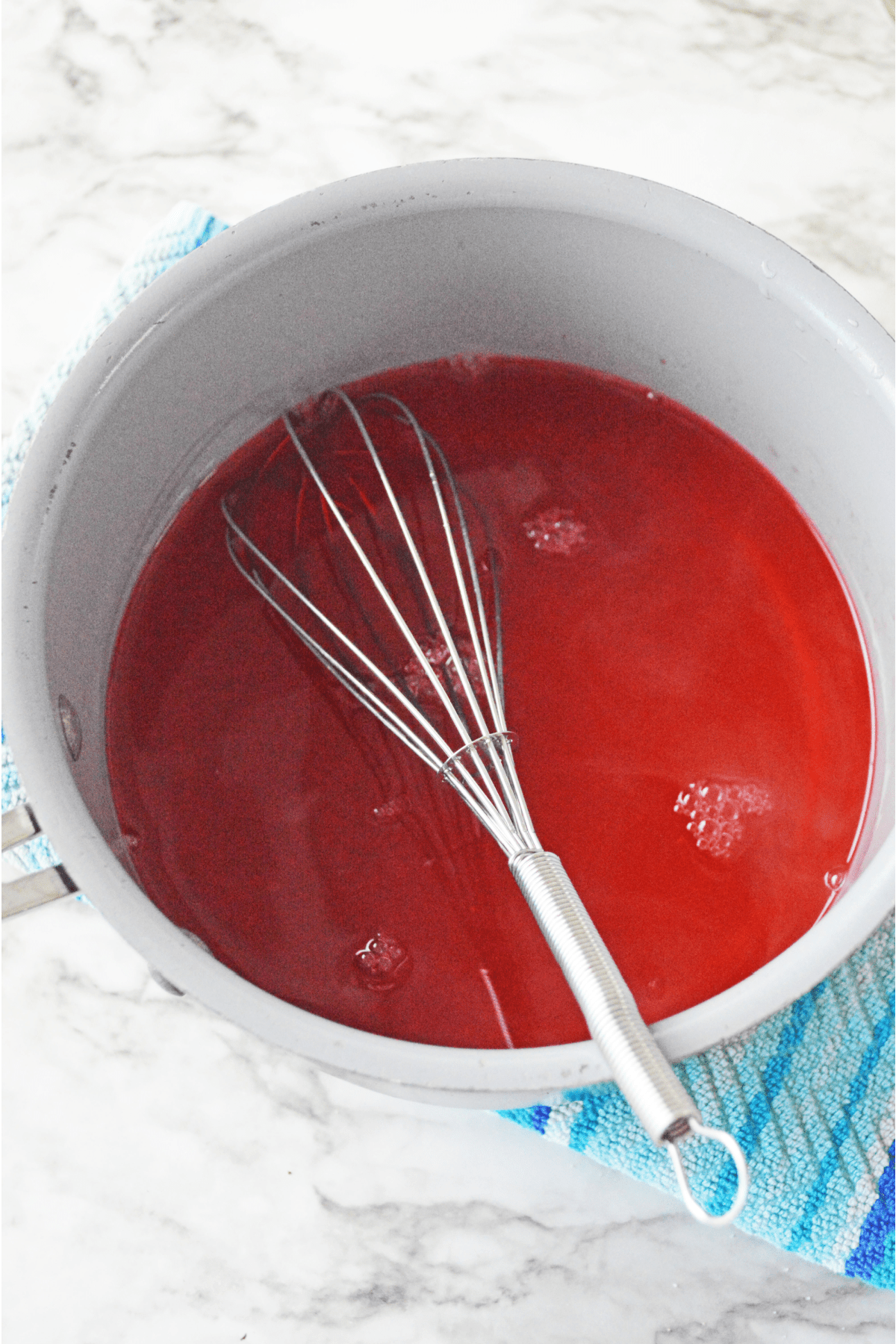 Mixing red jello shots in saucepan