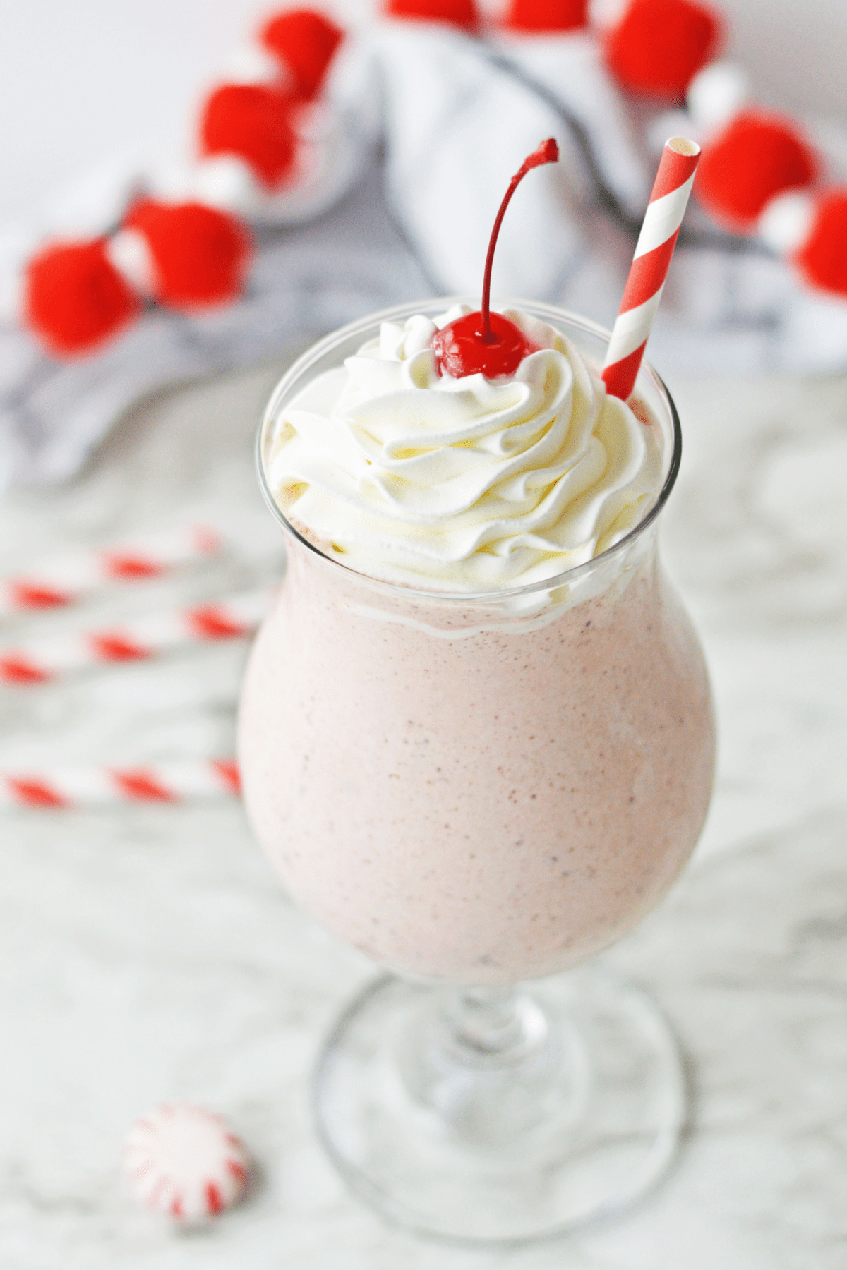 Copycat Chick Fil A Peppermint Milkshake with whipped cream and a cherry