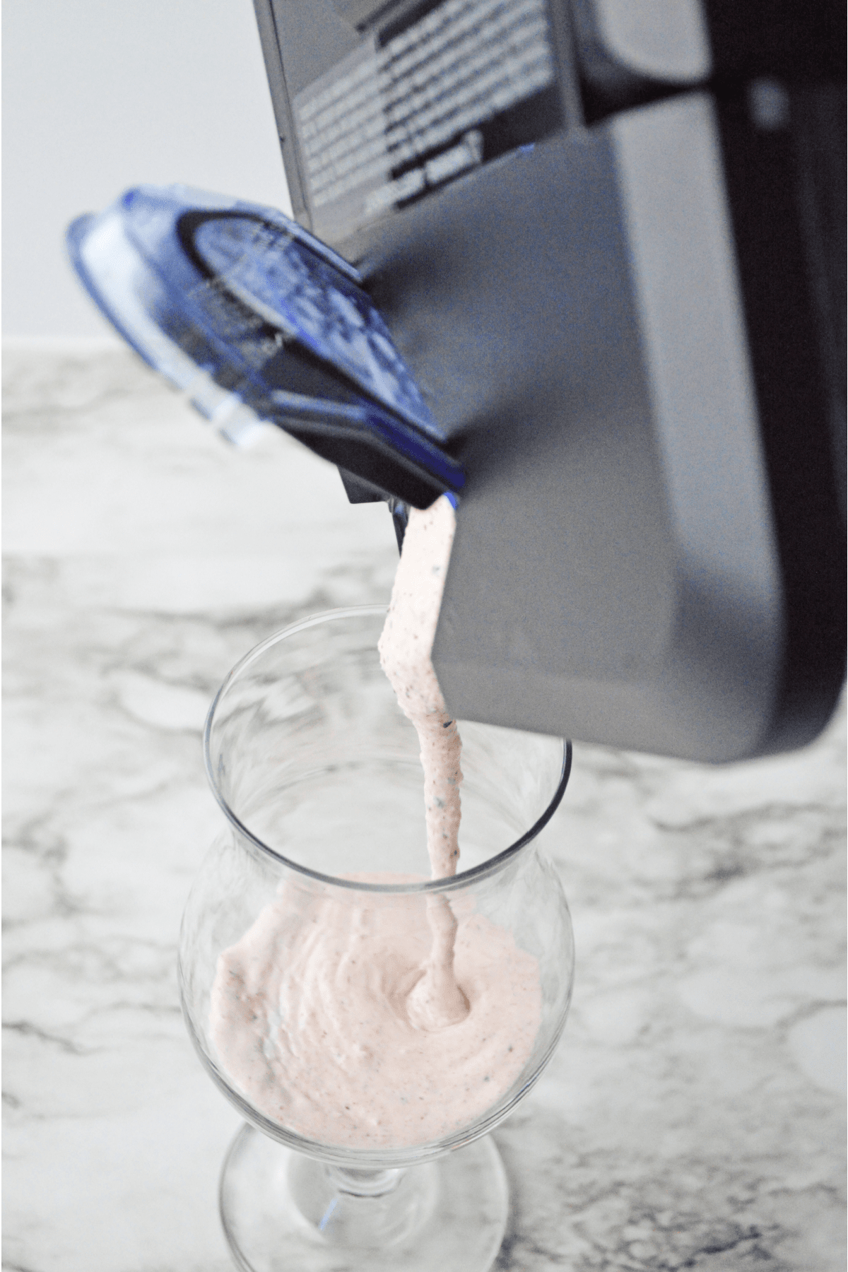 Pouring milkshake into hurricane glass