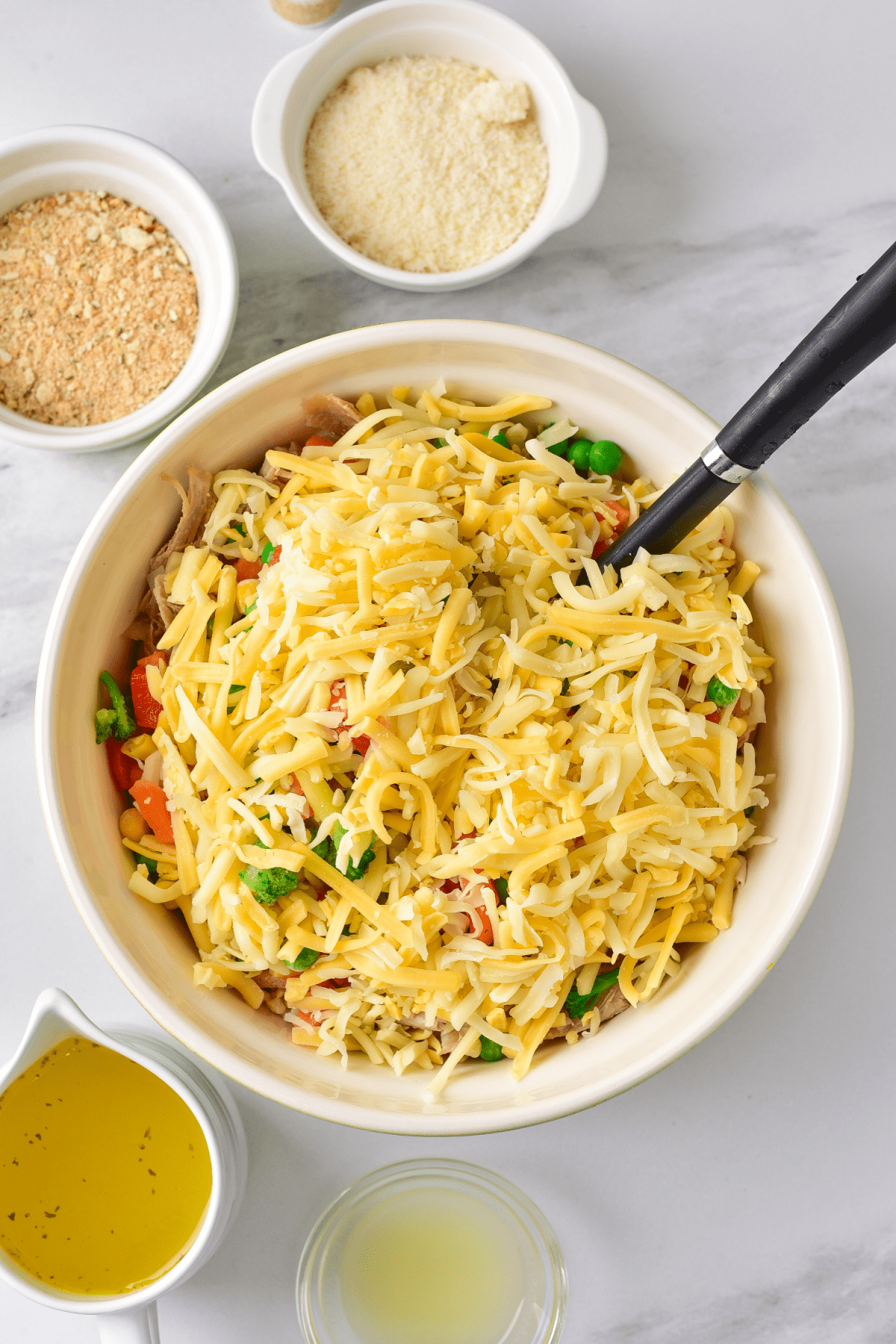 Cheese, turkey and vegetables in a mixing bowl