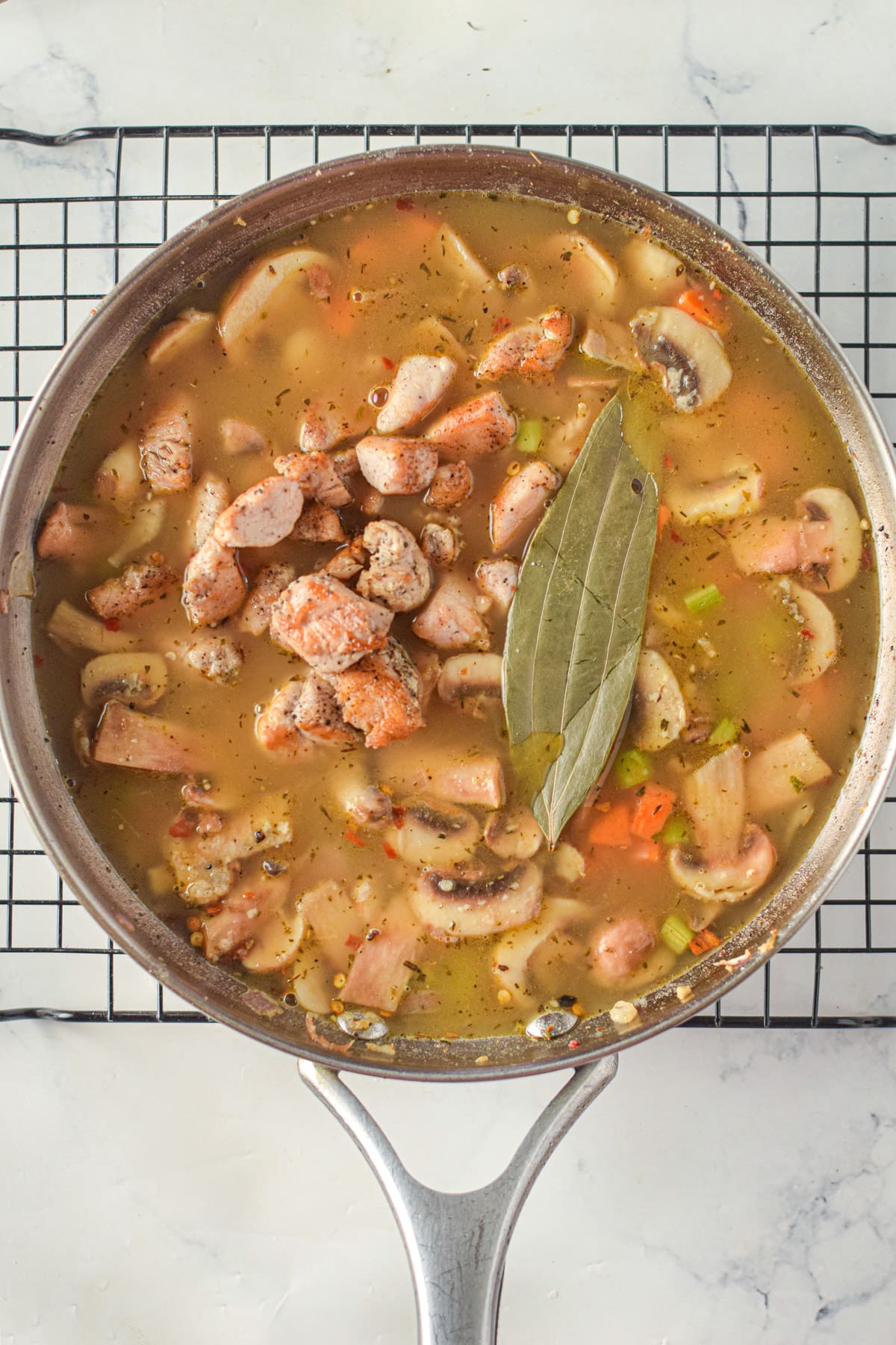 Chicken broth with chicken and bay leaf
