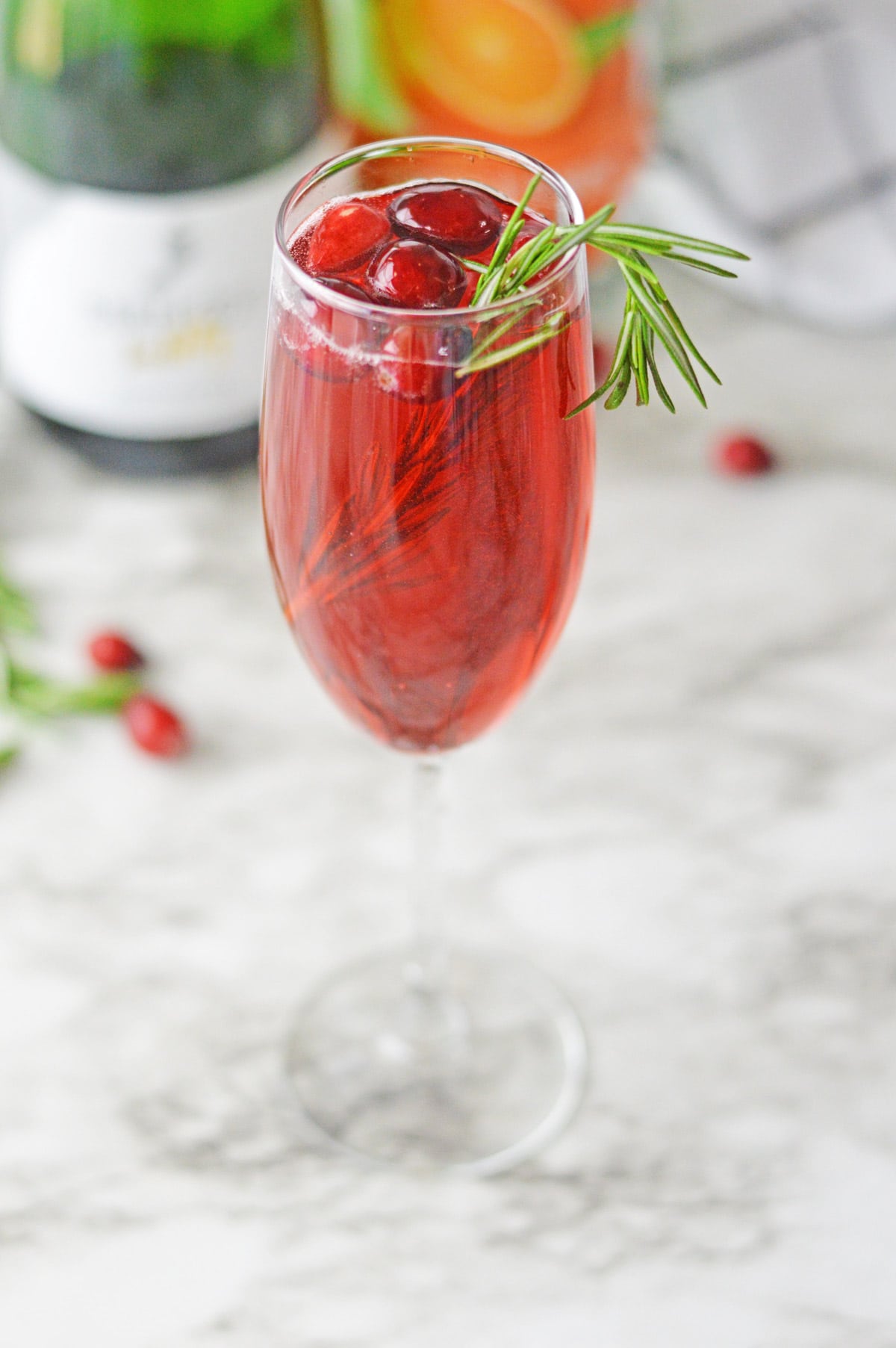 Poinsettia Champagne Cocktail with cranberries and rosemary