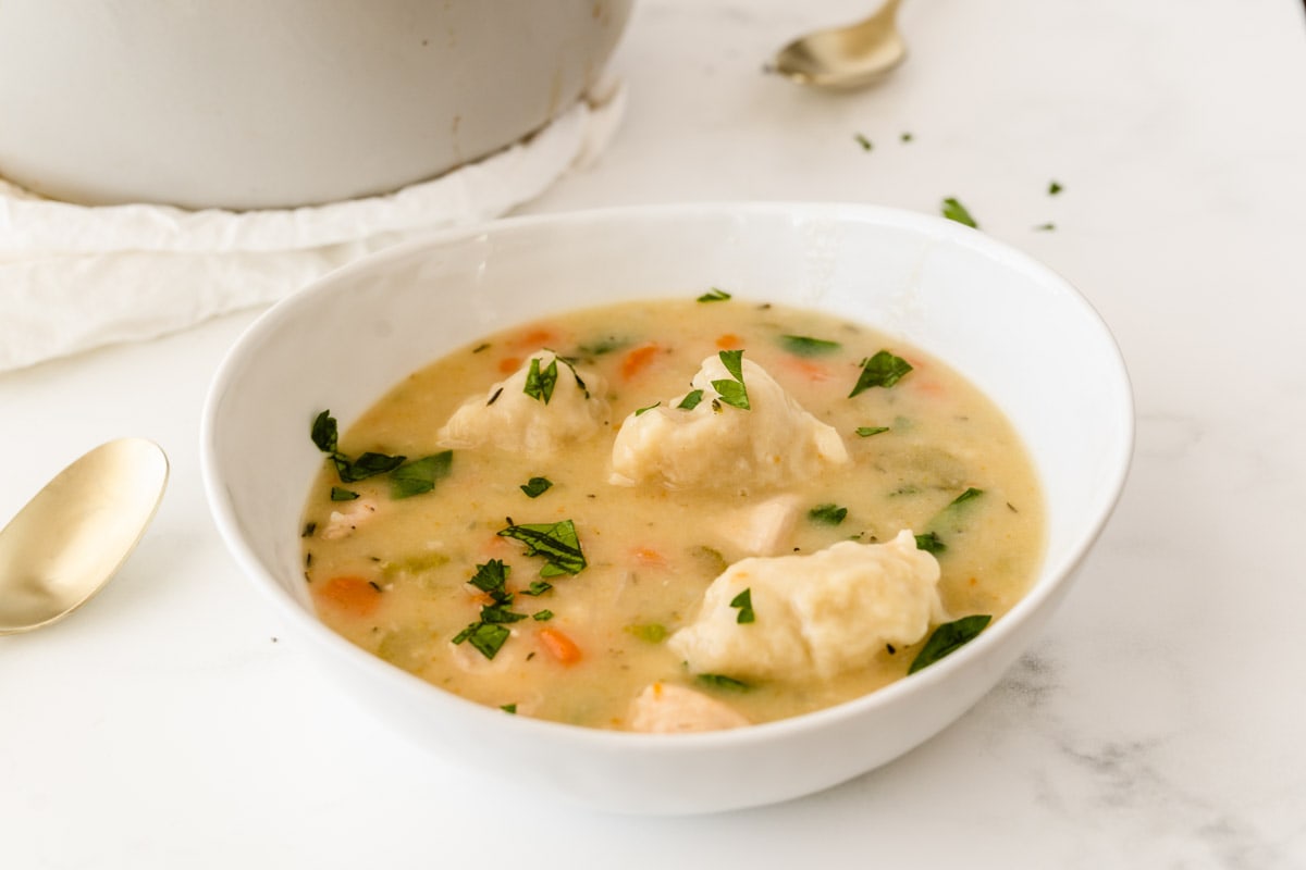White bowl filled with homemade chicken and dumpling soup