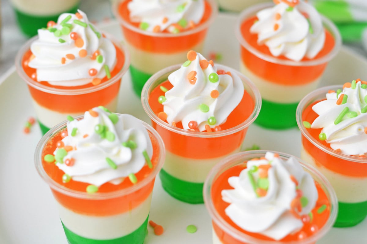 Irish flag jello shots topped with whipped cream and sprinkles