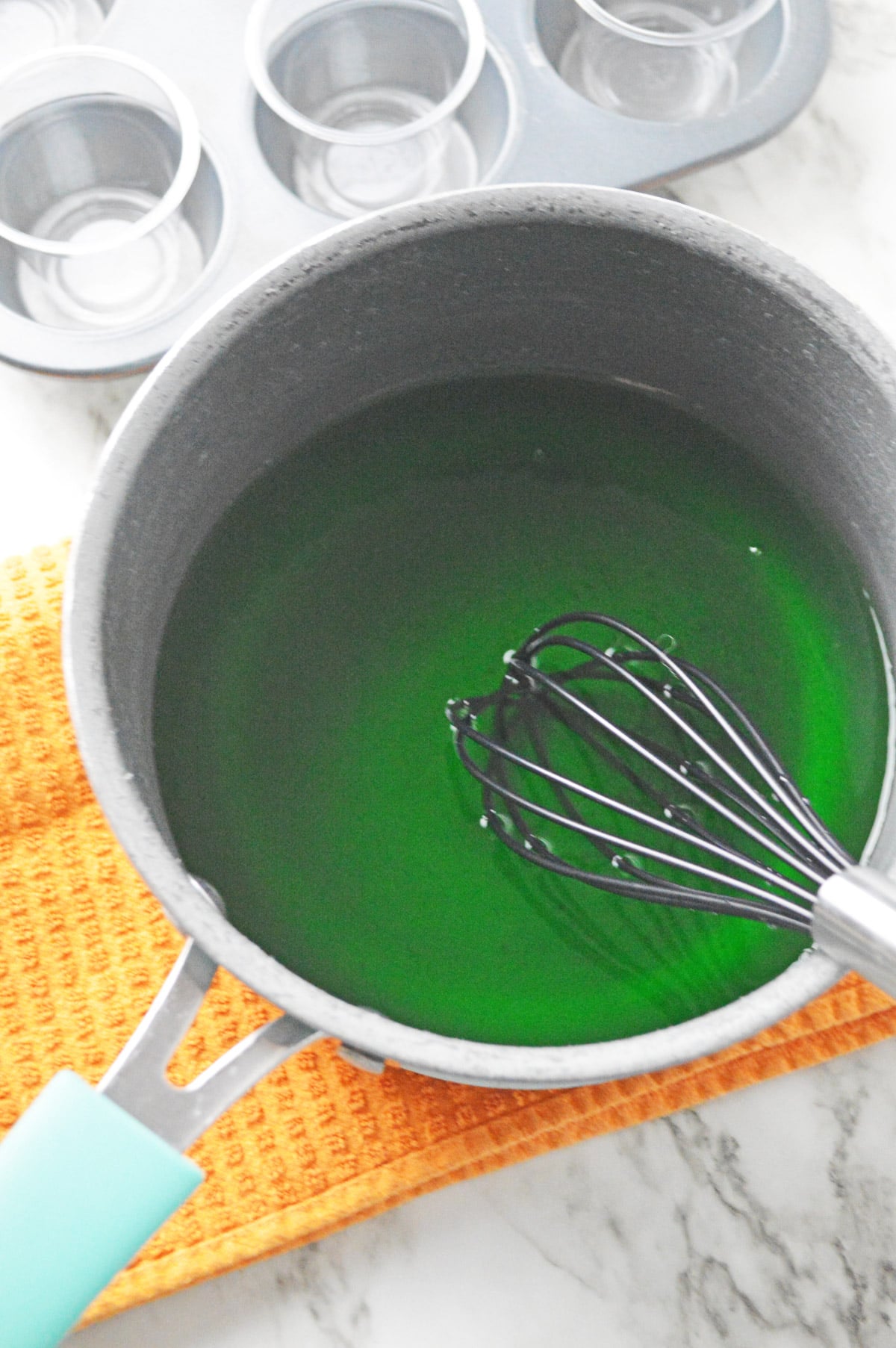 Whisking green jello ingredients together
