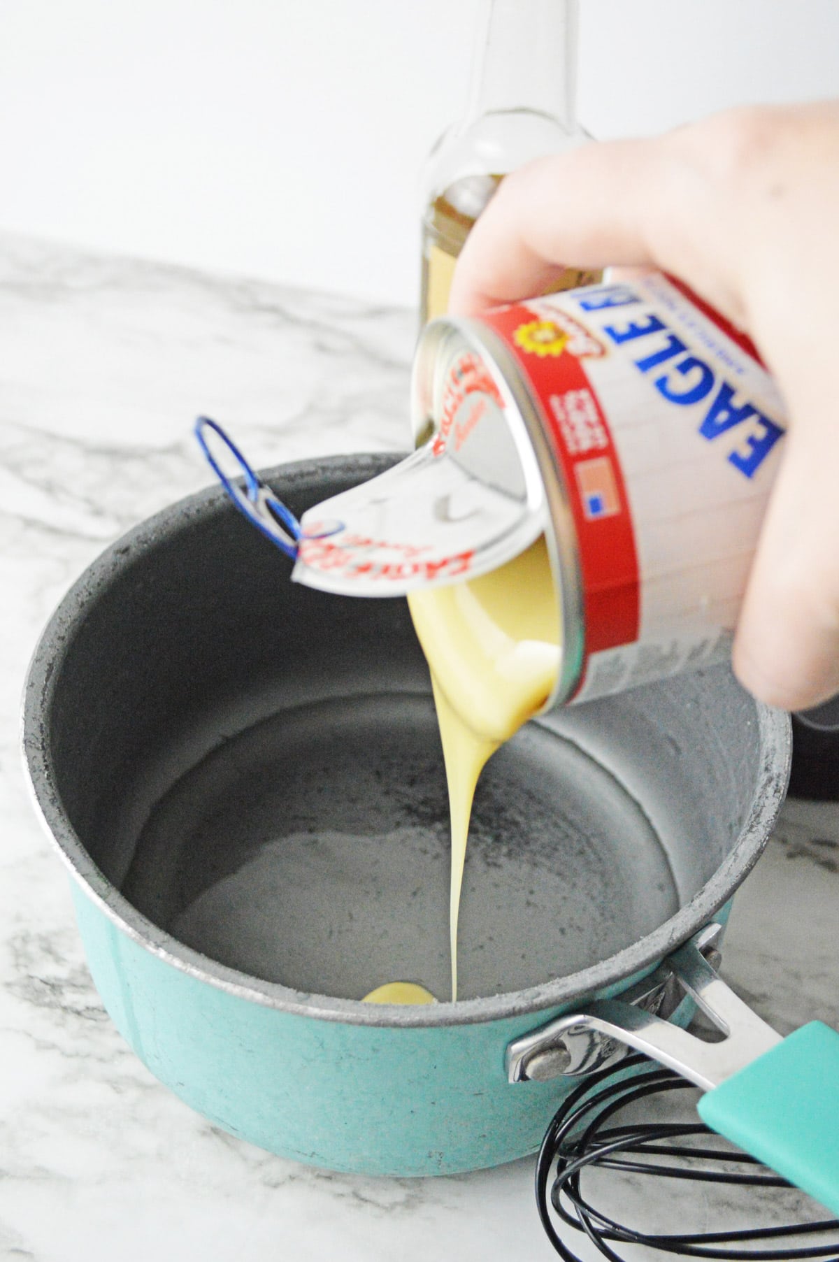 Pouring condensed milk into saucepan with water