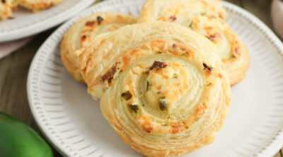 Jalapeno Popper Pinwheels on plate next to jalapenos