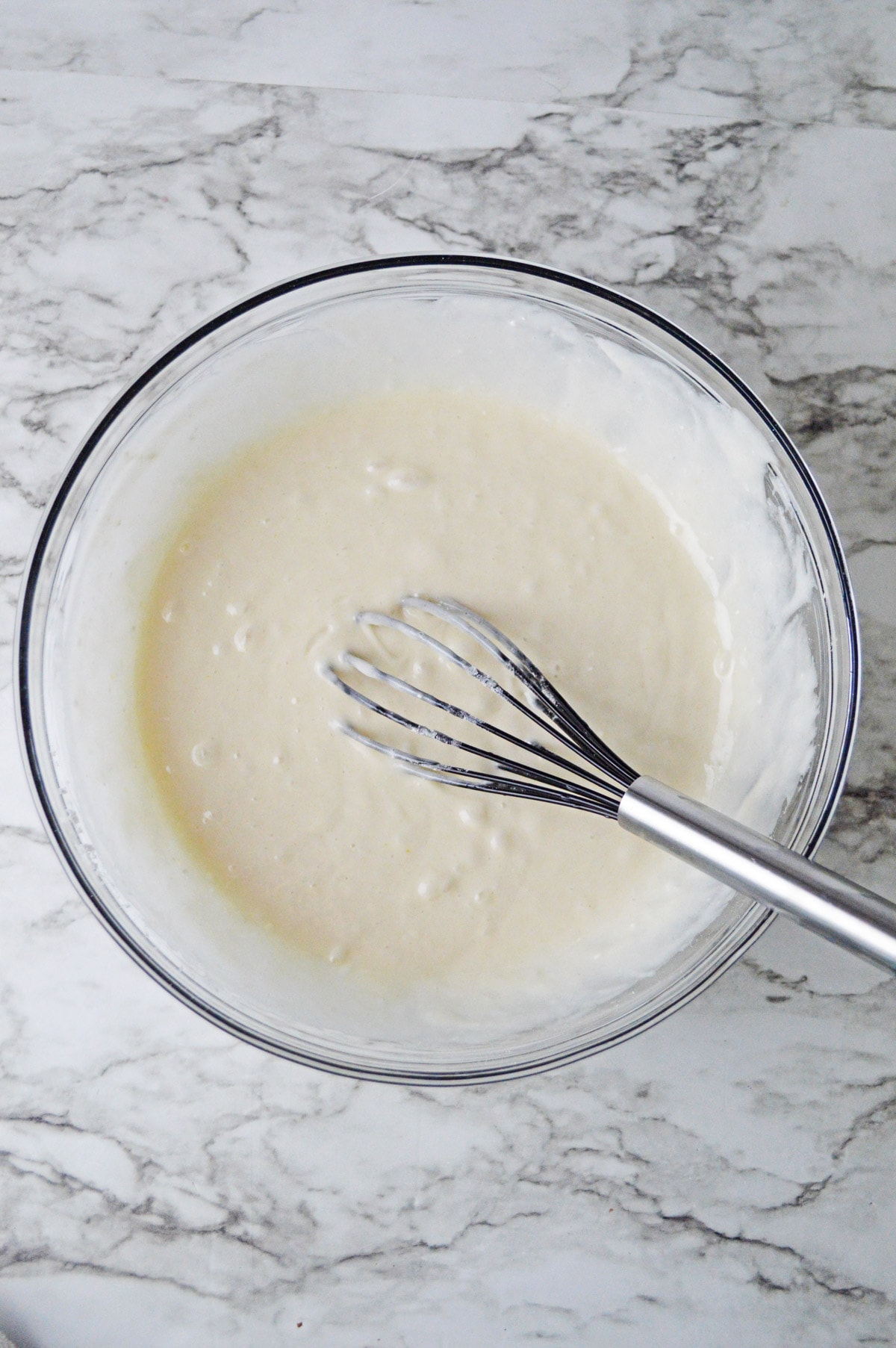 Cake batter in mixing bowl with whisk