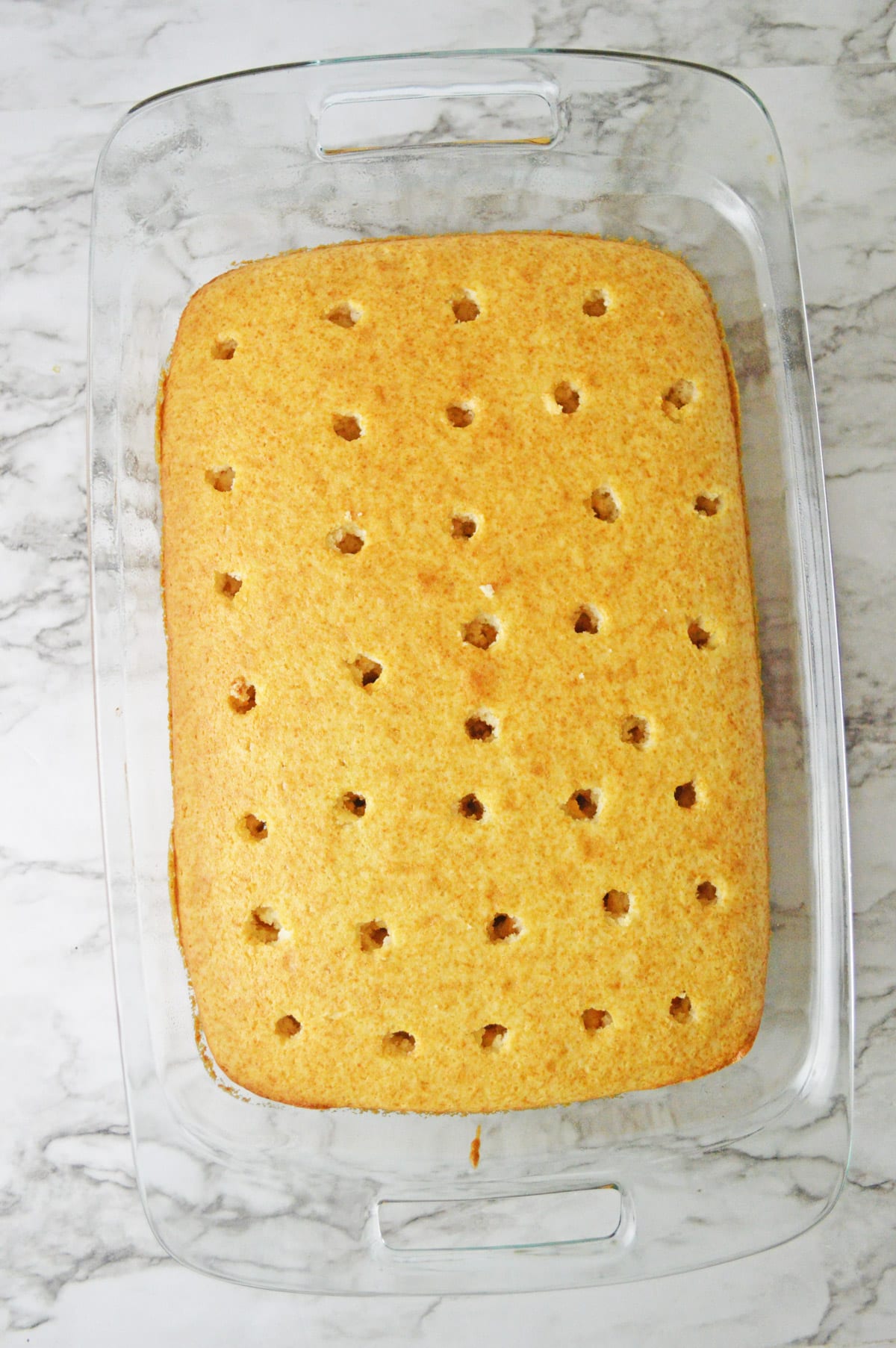 Rectangular cake with holes poked in it