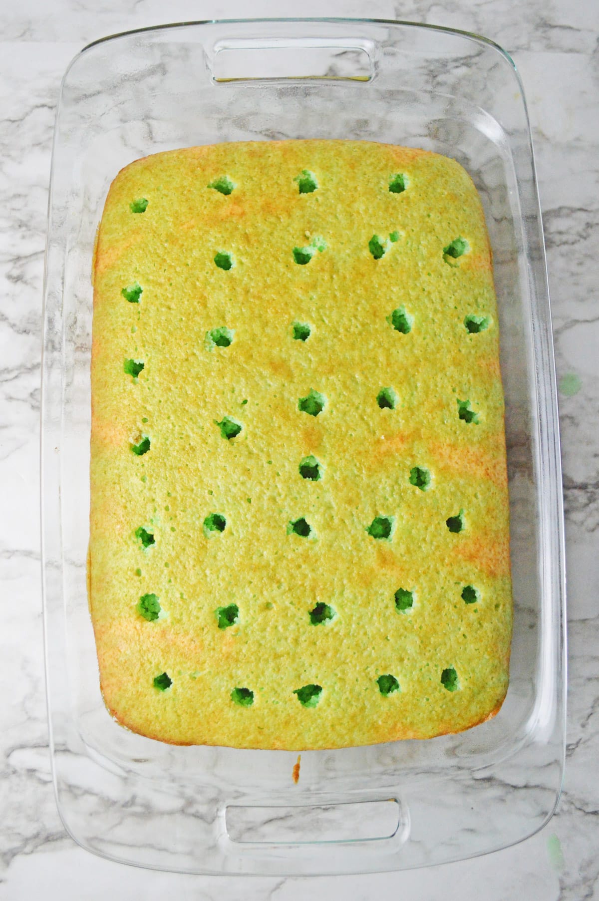 Cake with holes poked in it and jello poured in