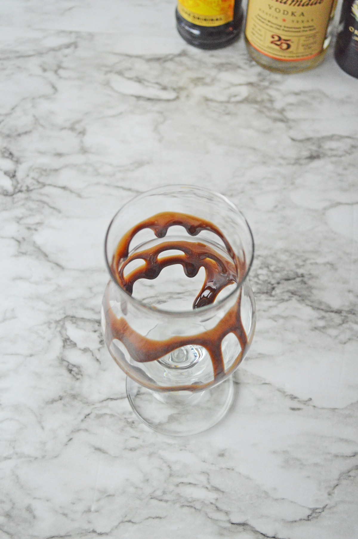 Glass drizzled with chocolate syrup