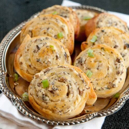 Cheesy pinwheels with mushrooms on silver plate