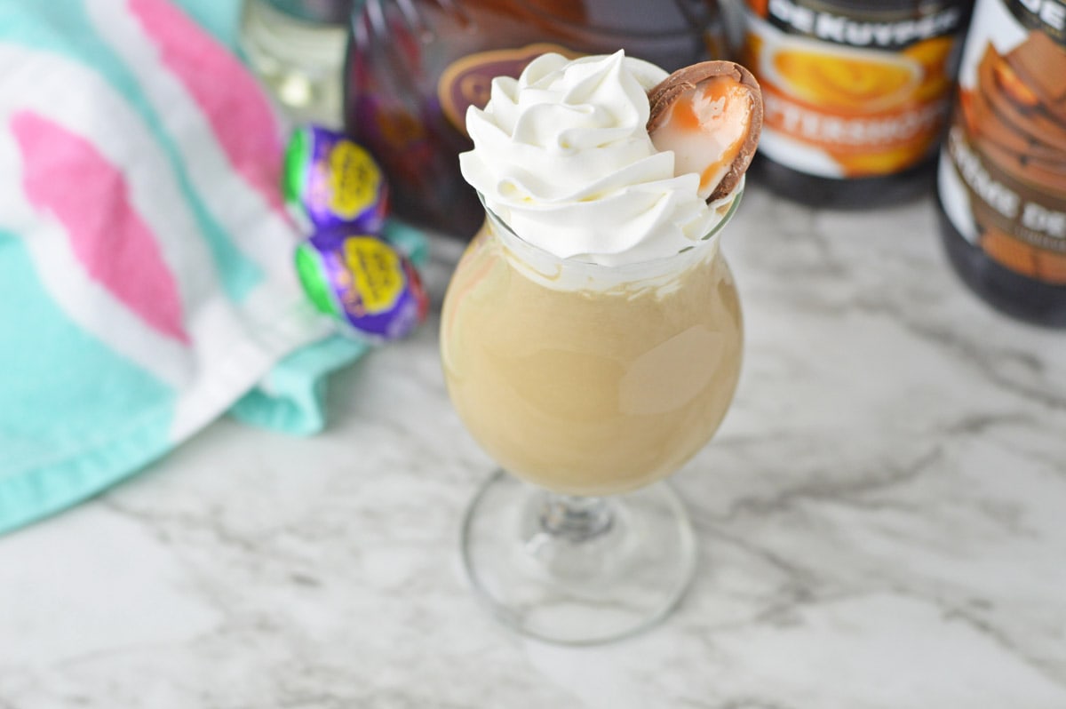 Cadbury Creme Egg Cocktail in hurricane glass with Easter towel