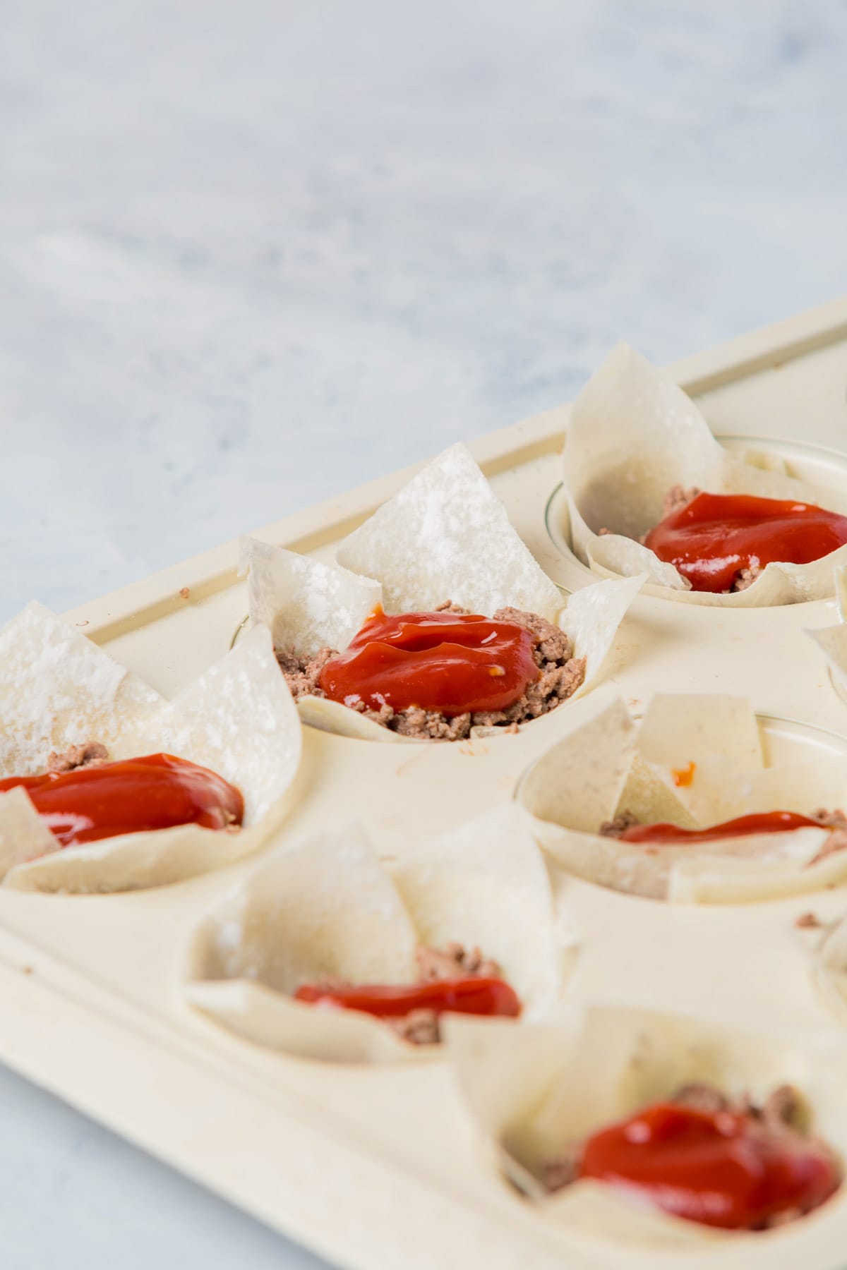 Wonton wrappers with ground beef and ketchup