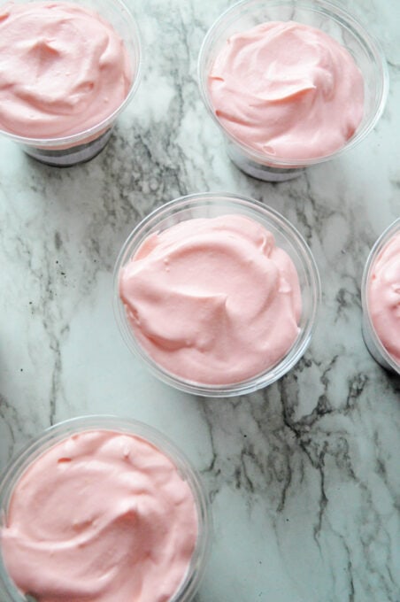 Pink pudding layer in plastic cups