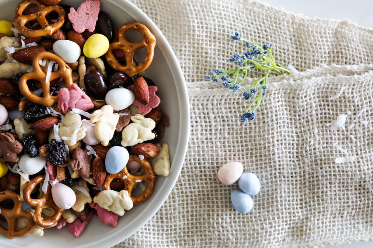 Half of a bowl of Easter Snack Mix with three chocolate eggs