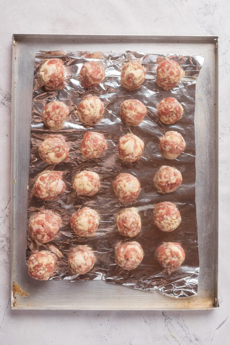 Uncooked sausage balls on baking sheet