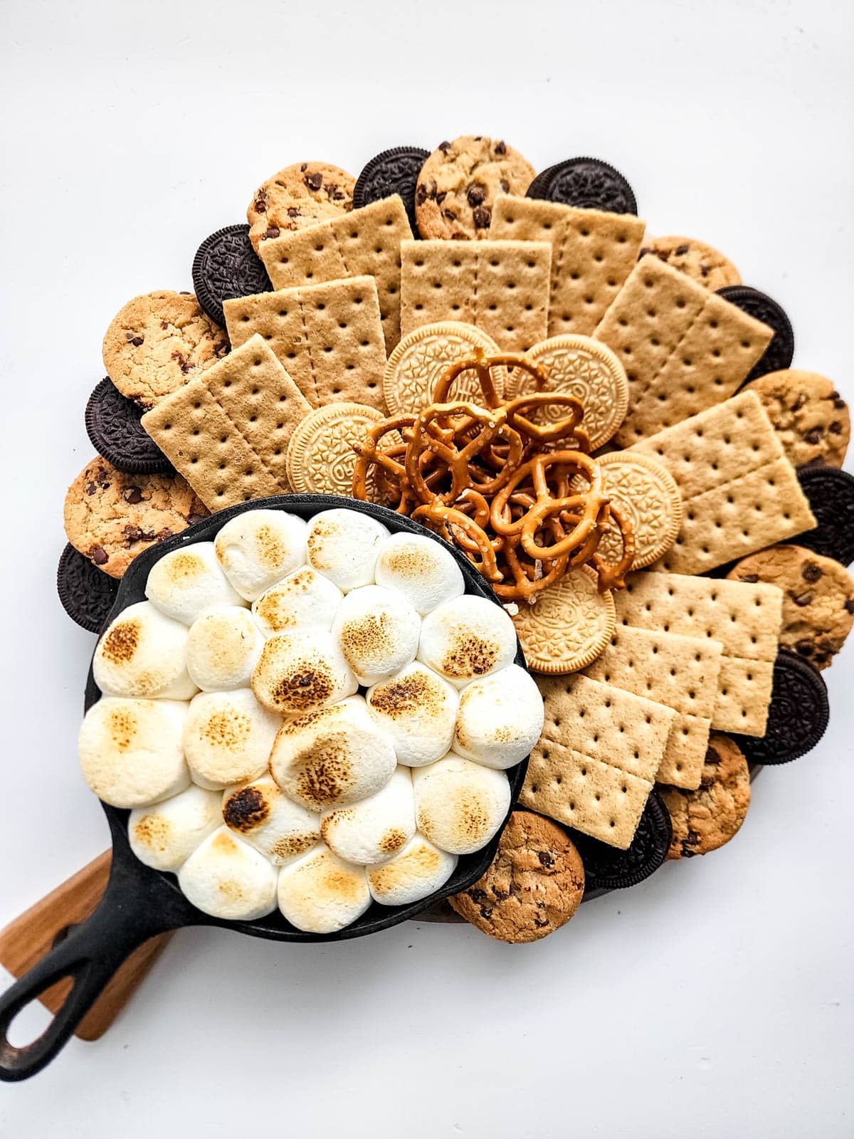 Charcuterie board with s'mores dip, pretzels, cookies and graham crackers