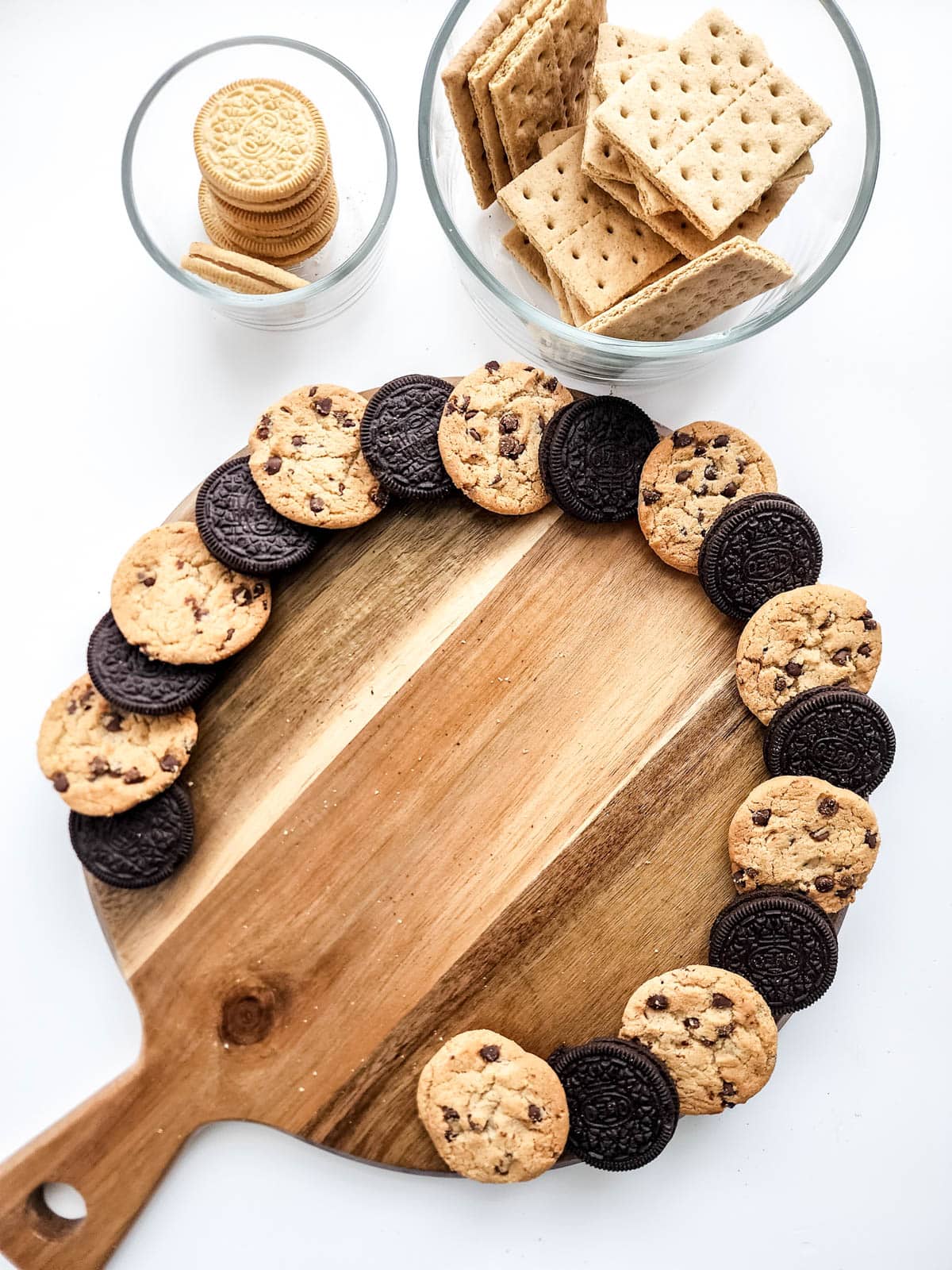Cookies on cutting board with more snacks in bowls