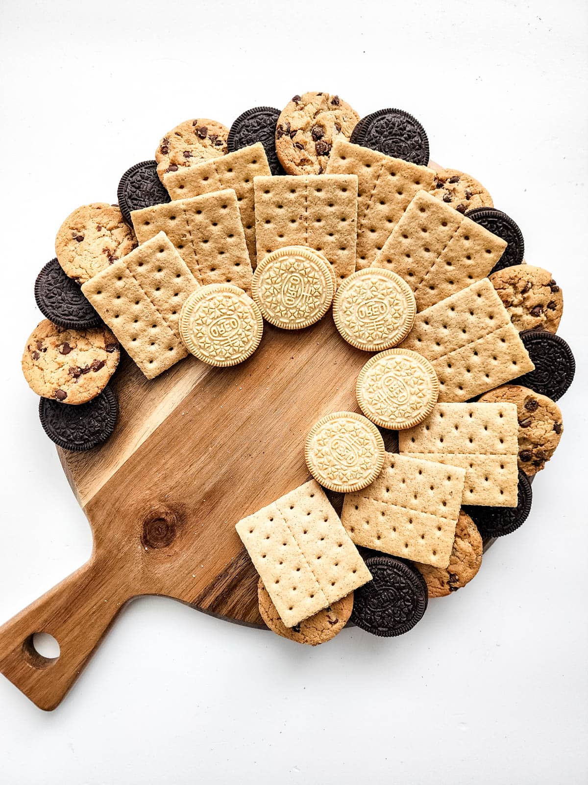 Wooden cutting board with cookies and graham crackers
