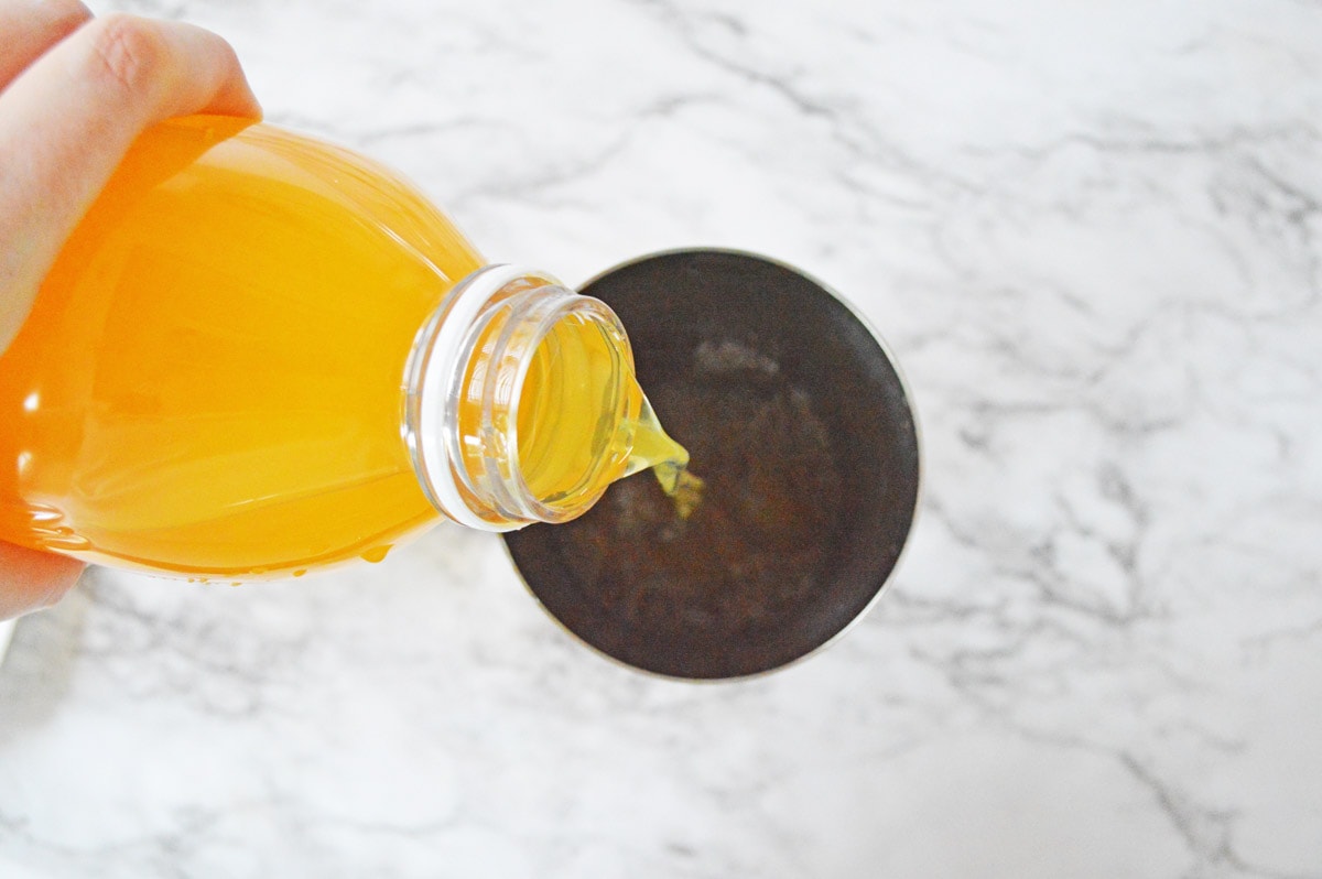 Adding mango juice to cocktail shaker