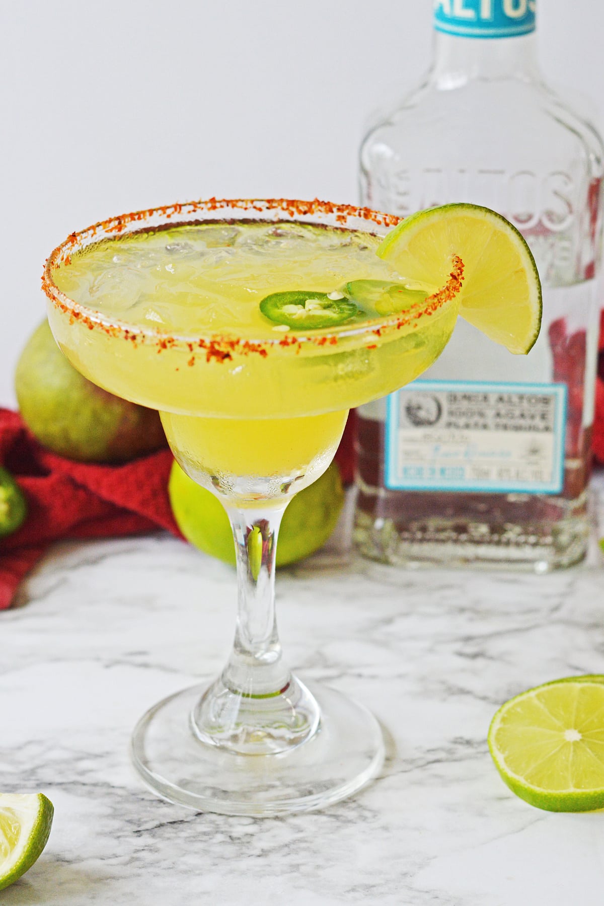 Spicy Mango Margarita with a lime wedge