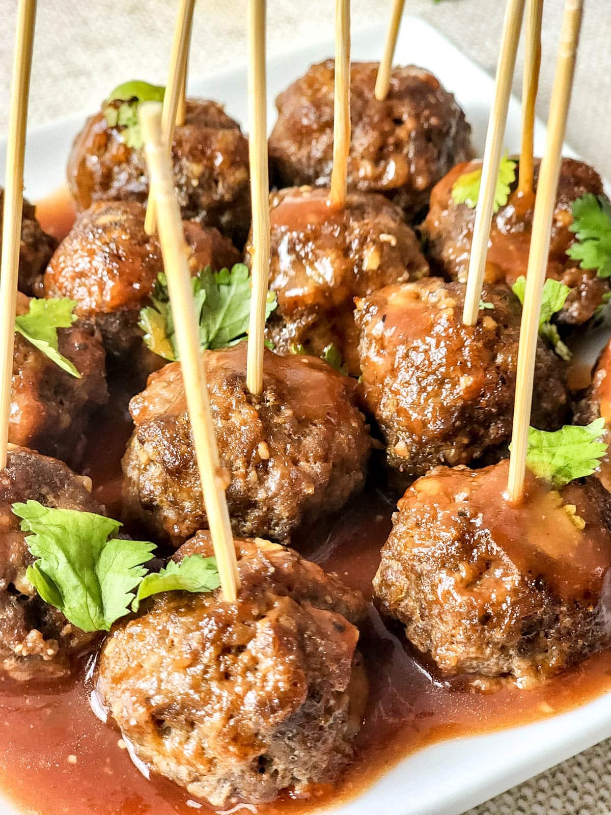 BBQ meatballs on plate with toothpicks